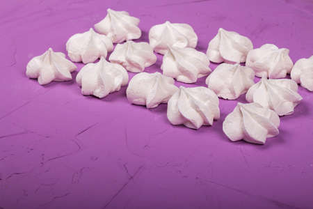 delicious meringue on a purple background, sweetnessの写真素材