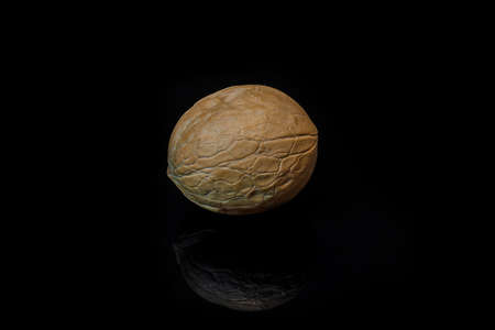 Walnuts isolated on black background with reflection, healthy food