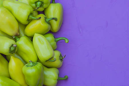 some green bell peppers on lilac background, top viewの写真素材