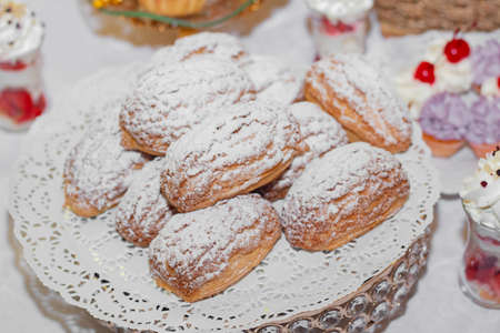 Stylish luxury decorated table with desserts for a happy couple's wedding celebration, catering in...