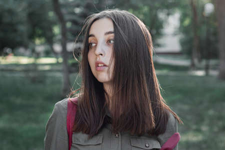 Portrait of a beautiful young woman in a summer park. Cinematic photo processing.の写真素材