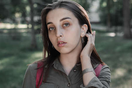 Portrait of a beautiful young woman in a summer park. Cinematic photo processing.の写真素材