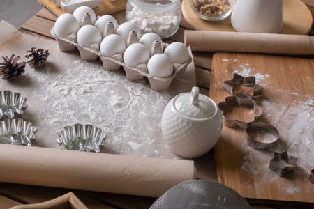 A composition of ingredients for delicious homemade pastries on a wooden table.