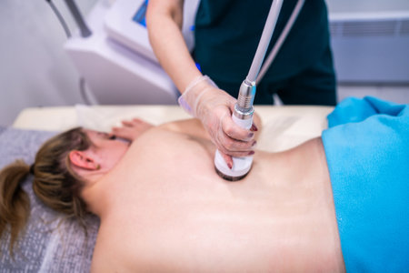 RF massage. Hardware cosmetology. Young woman getting rf lifting procedure in a beauty parlour.の写真素材