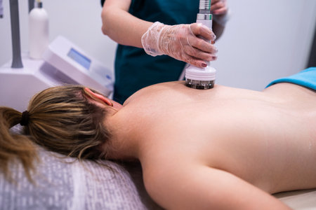 RF massage. Hardware cosmetology. Young woman getting rf lifting procedure in a beauty parlour.