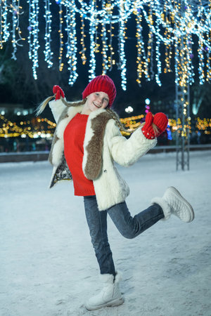Beautiful child smiles on a New Year's background. A girl with blue eyes Caucasian, very cute sweet baby smile. New Year lights bokehの写真素材