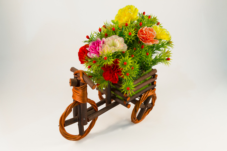 Beautiful and colorful flower bouquet in wooden basket in car shapeの写真素材
