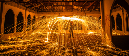 Burning steel wool fireworks in abandoned building.