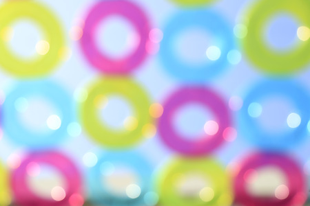Pattern of colorful pool rings against blue sky - Defocus bokeh for backgroundの写真素材