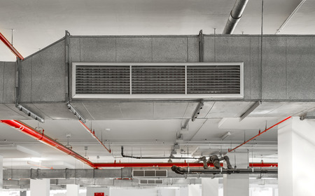 Industrial air duct ventilation equipment and pipe systems installed on industrial building ceiling.の写真素材
