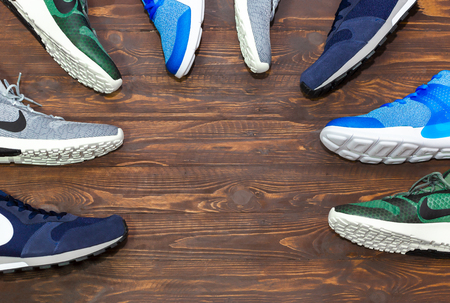 Bangkok, Thailand - September 2, 2018 : Top view shop display of Nike CK Racer, Arrowz, MD Runner 2 modern new stylish sneakers running shoes for men on wooden background texture with copy space.のeditorial素材