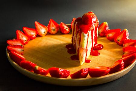 Strawberry cheesecake isolated on black backgroundの写真素材