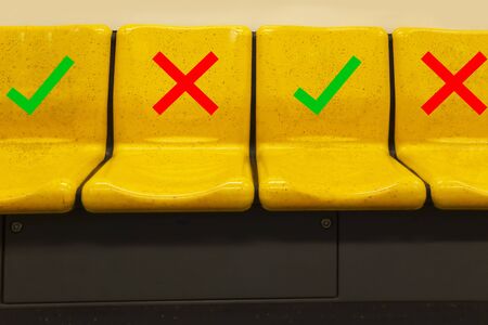 Social Distancing sign on passenger seat in BTS sky train. Keeping distance to protect from COVID-19 corona virus diseases. Idea for COVID-19 outbreak and prevention in public transportation.の写真素材