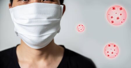 A man wear breathing medical respiratory mask against the Coronavirus (CoVID-19) isolated on white...