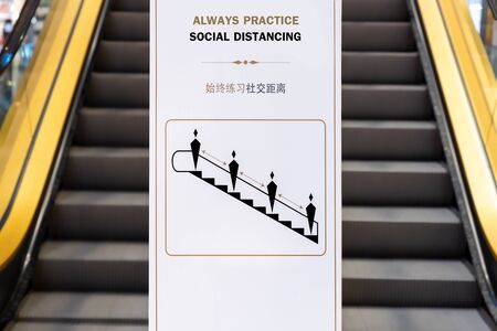 Social distancing sign for warning to keep social distance between each other to protect (CoVID-19) when on escalators..の写真素材