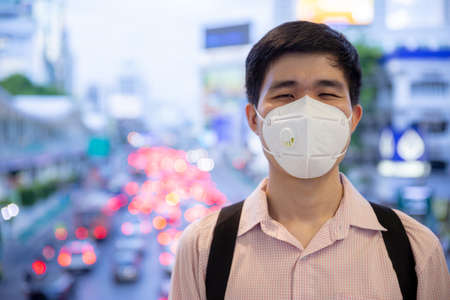 Asian man smiling behind medical protective mask in new normal lifestyle concept.の写真素材