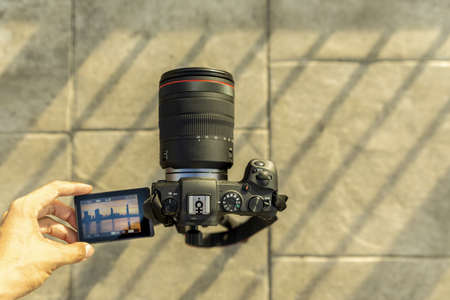 Photographer or traveller using a professional DSLR camera for background.