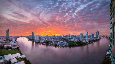 Panorama view of modern buildings in the city with water reflection, firework, light show at twilight time.の写真素材