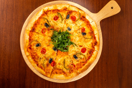 Top view of Margherita pizza on wooden table.の写真素材
