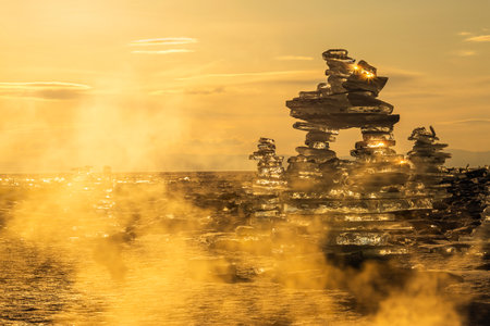 Sunset reflected in a large block of ice hummock on the frozen lake background.の写真素材