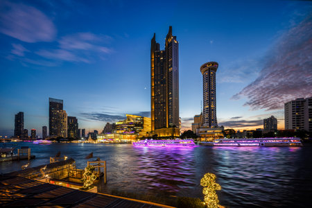 Modern buildings in the city with water reflection, firework, light show at twilight time.の写真素材
