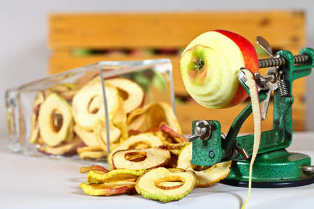 Dried Apples with a whole Apple which is getting prepared for drying.の写真素材