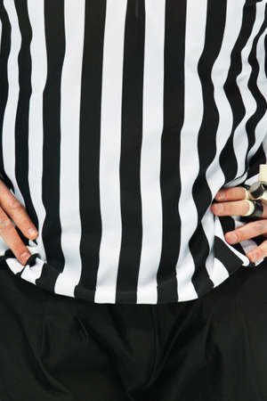 An Ice Hockey Referee ist standing with his arms on his chestの写真素材