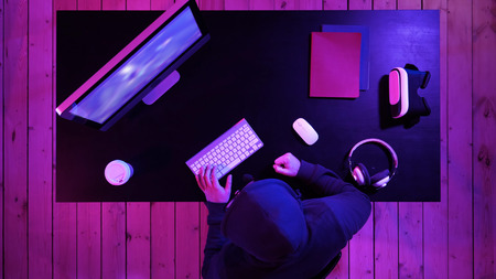 Gamer cries going crazy of defeat in the video game hitting table with his fist.の写真素材