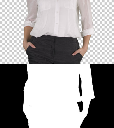 Relaxed business woman with walking with hands in her pockets, Alpha Channelの写真素材