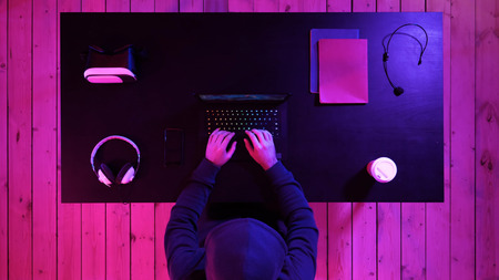 Gamer playing a game on a laptop. Streaming and watching others play.の写真素材