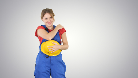 Construction woman laughing at someone behind the camera on gradient background.の写真素材