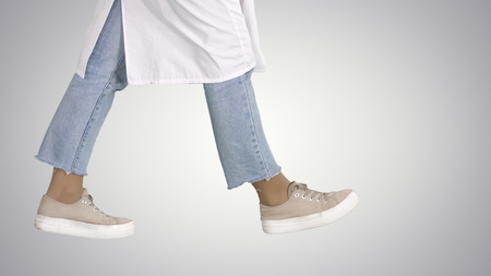 Woman doctor legs walking on gradient background.の写真素材