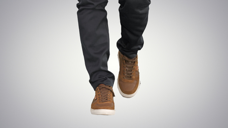 Men walking in autumn sneaker shoes on gradient background.の写真素材