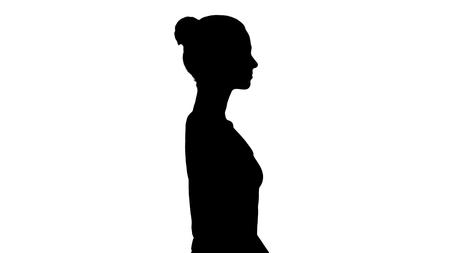Silhouette Casual young woman in white top walking.の写真素材