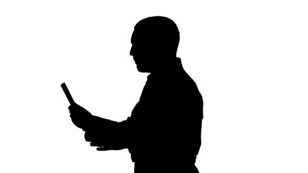 Medium shot side view. Silhouette Young Doctor Video Chatting On Tablet. Professional shot in 4K resolution. 004. You can use it e.g. in your commercial video, business, presentation, broadcastの写真素材