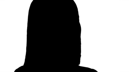 Silhouette Face of young cheerful businesswoman talking on mobile phone.の写真素材