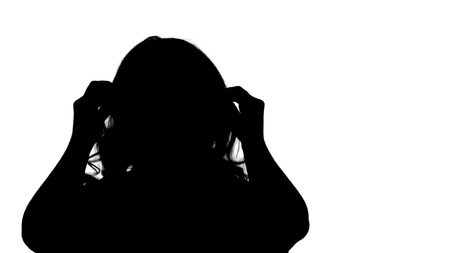 Silhouette Beautiful girl preens looking at camera.の写真素材
