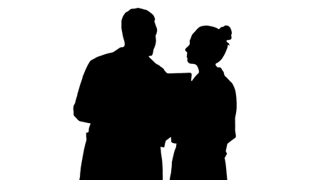 Silhouette Serious nice woman doctor and afro american doctor study brain x ray.の写真素材