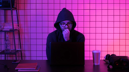 Gamer or streamer watching stream on a laptop.の写真素材