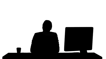 Silhouette Excited business woman talking on camera sitting at desk.の写真素材