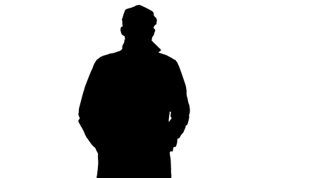 Medium shot. Silhouette Confident man in trench holding hands in the pockets and walking. Professional shot in 4K resolution. 006. You can use it e.g. in your commercial video, business, presentation, broadcastの写真素材