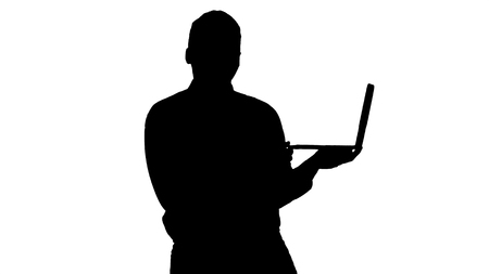 Medium shot. Silhouette Talking to camera young african man with laptop in his hands. Professional shot in 4K resolution. 012. You can use it e.g. in your commercial video, medical, business, presentation, broadcastの写真素材