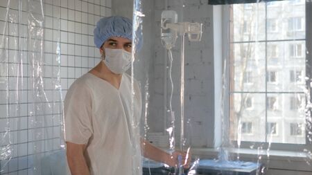 Isolated man despairing at hospital quarantine caused by coronavirus.の写真素材