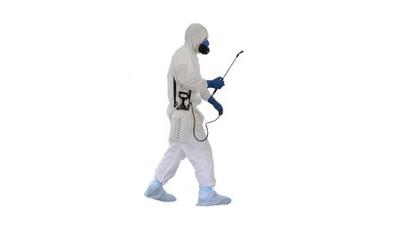 Scientist in hazmat suit walking and disinfecting against biohazの写真素材