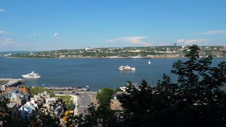 Quebec City skyline panorama over river with blue sky.