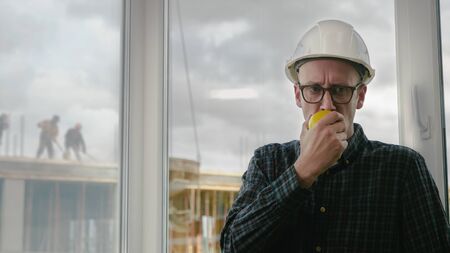 Construction worker eating an apple.の写真素材