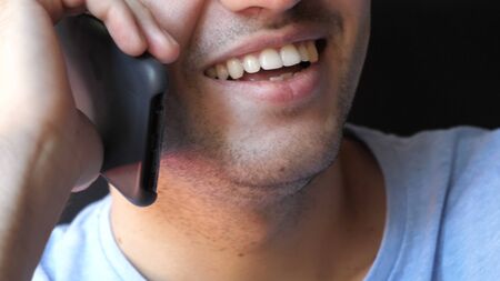 Close up.Smile of a man talking on the phone. Professional shot  02. の写真素材