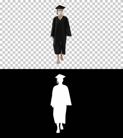 Female Graduate in Cap and Gown Wearing Medical Mask Walking, Alpha Channelの写真素材