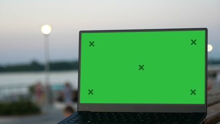 Laptop on a bench in a street.の写真素材