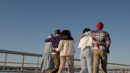 Best friends concept - group of happy friends hugging and walkinの写真素材